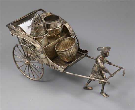 A late 19th/early 20th century Chinese white metal condiment stand by Luen Wo?, modelled as a rickshaw, length 19cm.